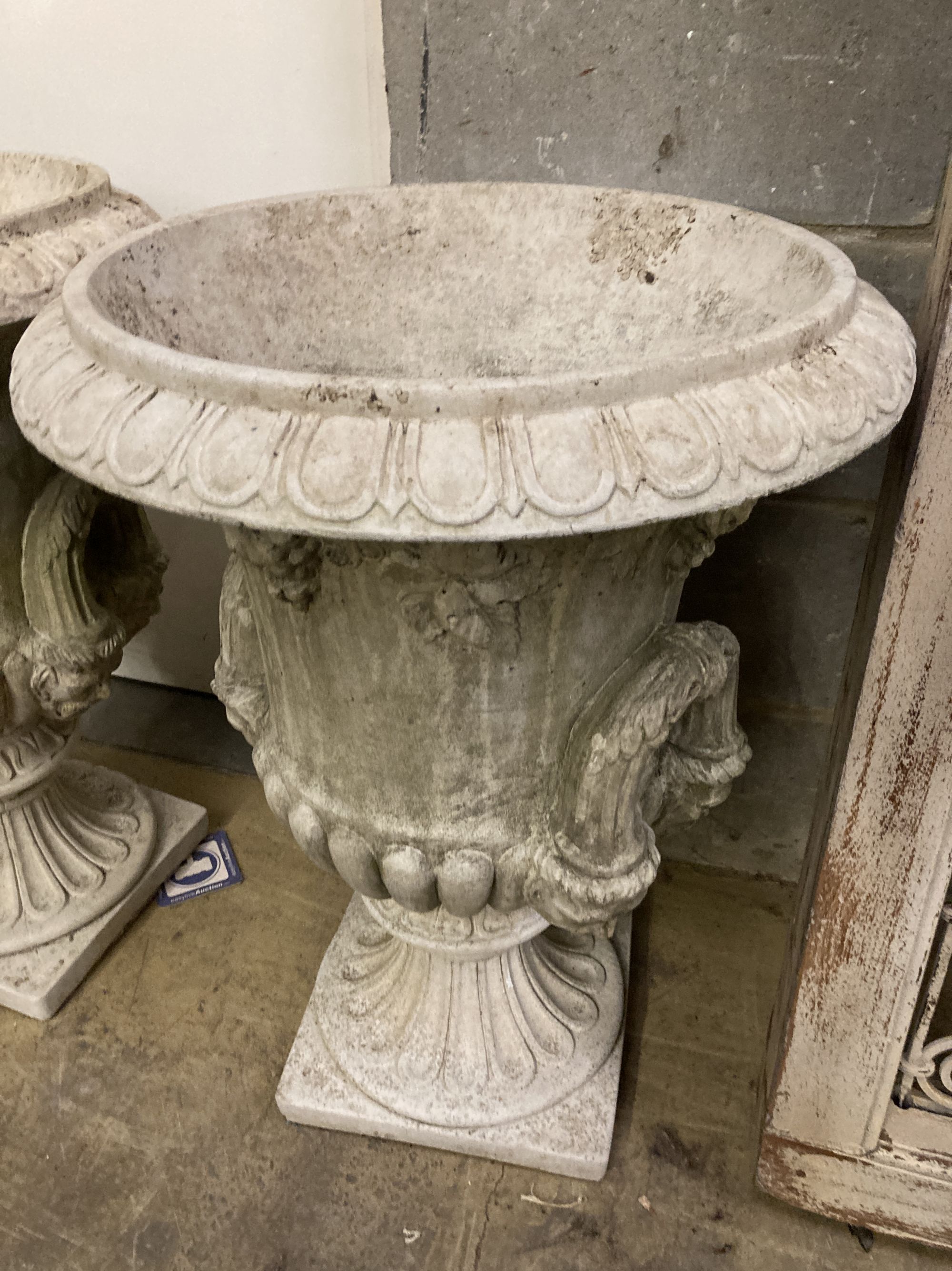 A pair of reconstituted stone campana shaped garden urns, diameter 54cm, height 72cm